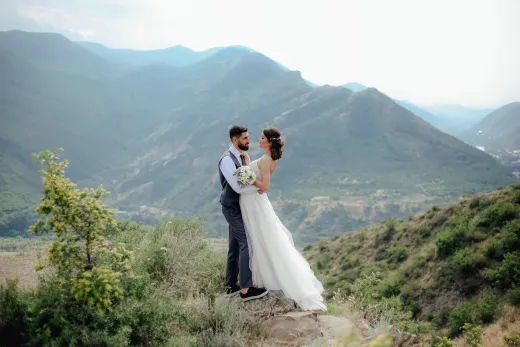 Bride and groom embracing on a mountaintop s - Weddings (General)