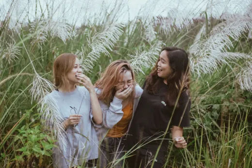 Three women enjoying a lighthearted moment a - Marriage & Relationships