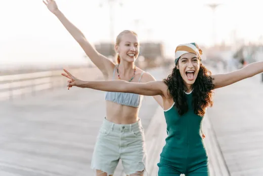 Two young women joyful and carefree on a sun - Marriage & Relationships