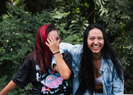 Two young women share a joyful moment outdoo - Marriage & Relationships