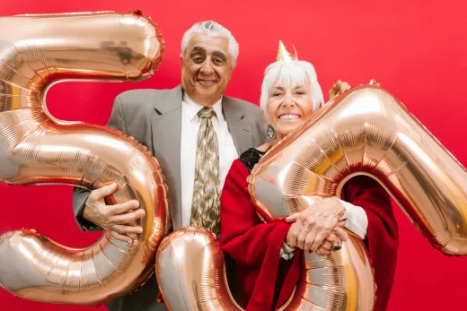 Cheerful senior couple celebrating with gold - Weddings (General)
