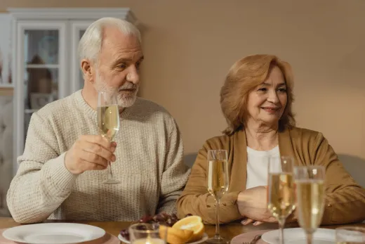 Elderly couple sharing a joyful toast with c - Weddings (General)