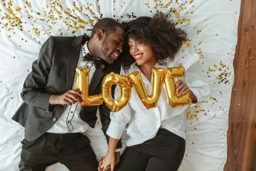 Smiling black couple lying on bed with love - Weddings (General)