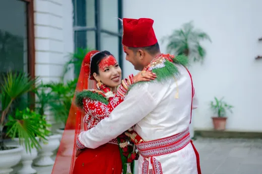 Couple in traditional attire embracing at an - Weddings (General)