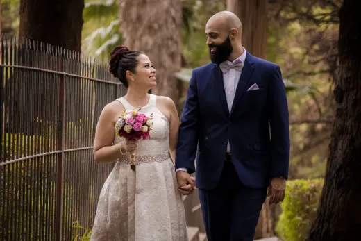 A joyous bride and groom walking outdoors ex - Marriage & Relationships
