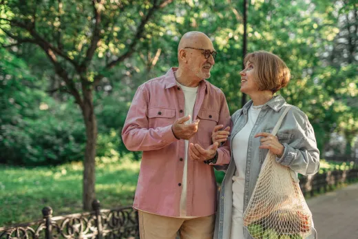 Senior couple walking together in a park enj - Marriage & Relationships