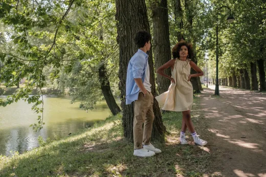 Teen couple in a park by a lake enjoying a s - Marriage & Relationships
