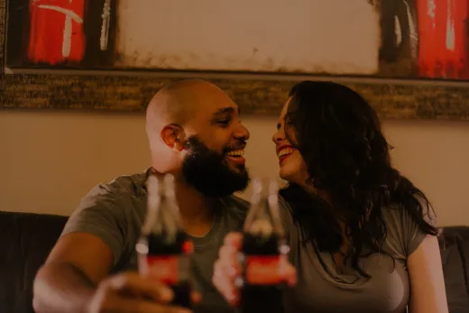 A joyful couple shares a soda and laughter i - Marriage & Relationships