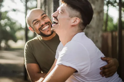 Happy interracial gay couple laughing and em - Marriage & Relationships