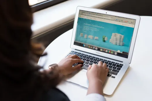 Businesswoman working on laptop with android - Marriage & Relationships