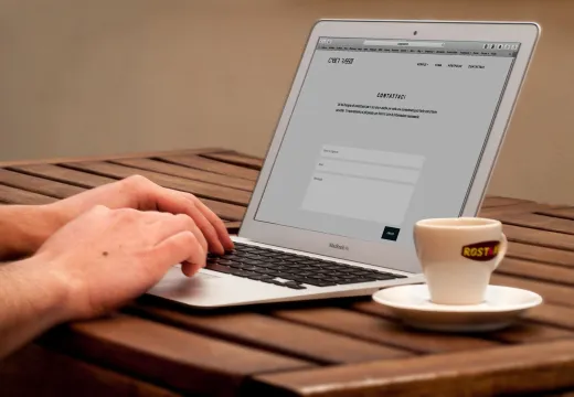 Close up of hands typing on a laptop next to - Marriage & Relationships