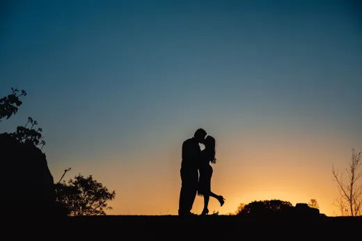 Silhouette of a couple kissing outdoors at s - Marriage & Relationships