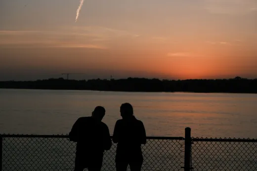 Two people silhouetted against a vibrant sun - Marriage & Relationships