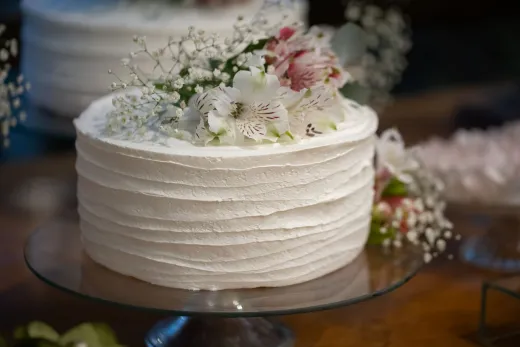 Beautiful white cake topped with flowers per - Weddings (General)
