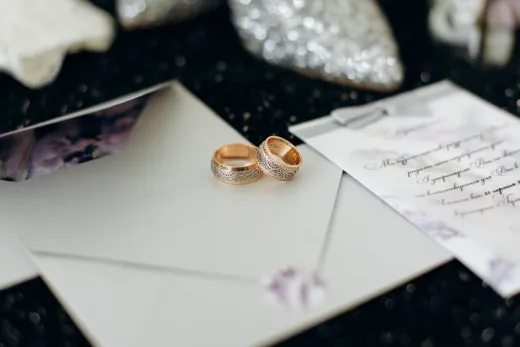 Close up of elegant wedding rings placed on - Invitations & Cards