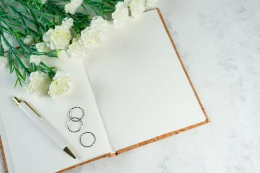 Open notebook with blank pages surrounded by - Weddings (General)