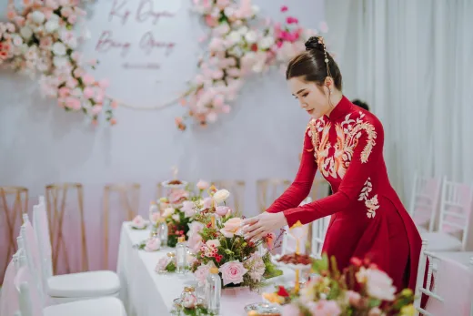An asian woman in traditional red dress arra - Wedding Planning & Budget